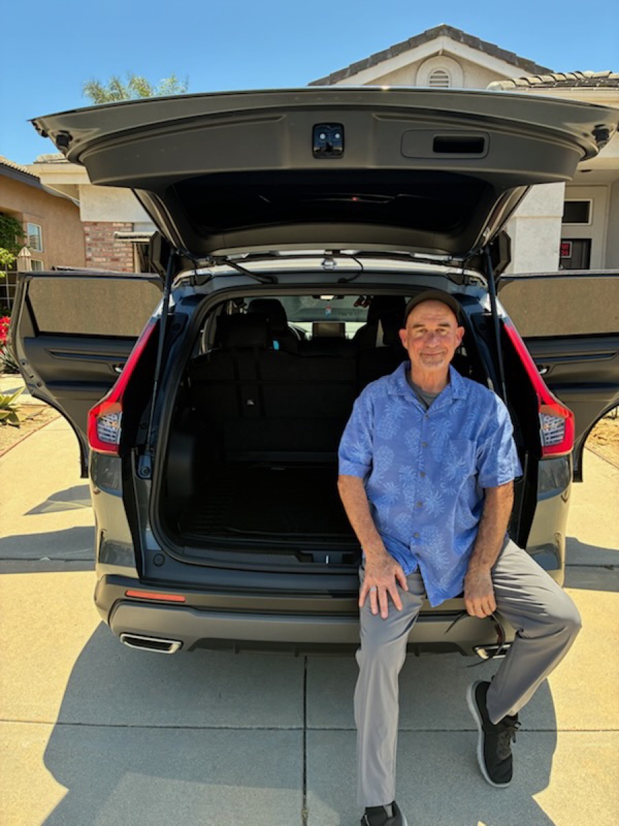 Open cargo area of Alan's 2023 Honda CR-V with plenty of room for luggage