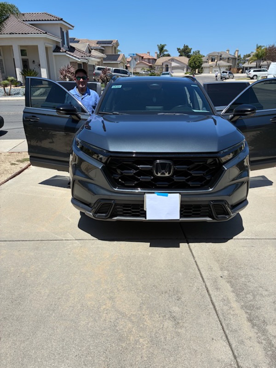 Alan, owner and driver of Safe Travels Shuttle, standing beside his 2023 Honda CR-V